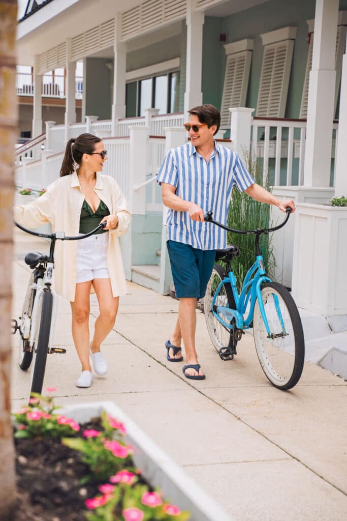 Couple bringing bikes into ICONA Diamond Beach