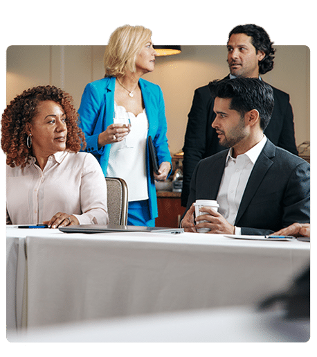 Coworkers around a table at a corporate event at ICONA Resorts