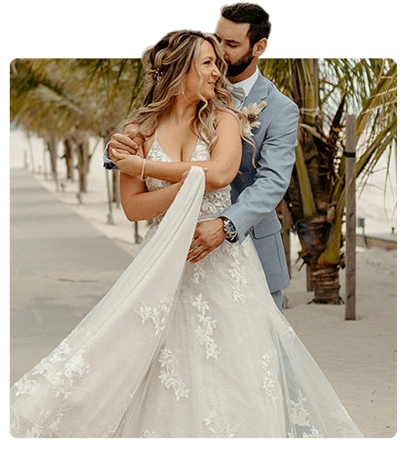 Bride and groom embracing at an ICONA beach wedding