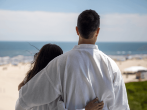 Couple on a balcony at ICONA Resorts looking out at the view