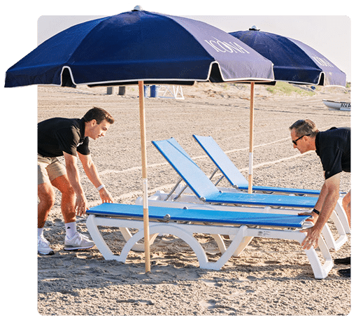 ICONA employees placing lounge chairs on the beach