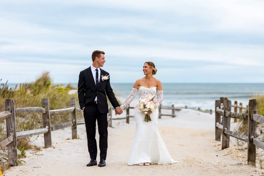 Bride and groom on the sand at an ICONA Avalon beach wedding