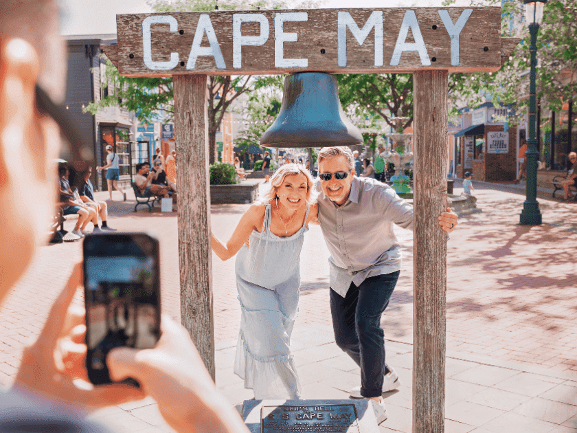 Couple posing under Cape May sign