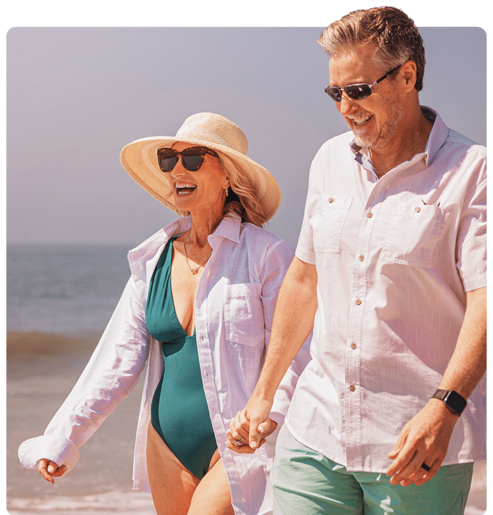 Couple walking on the beach outside ICONA Cape May beachfront hotel