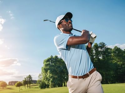 Man holding a golf club after a swing