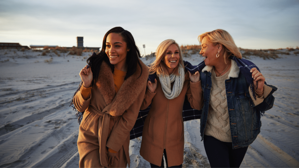 Friends walking on the beach in Avalon in the winter