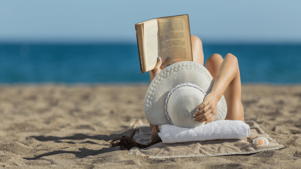 Woman reading a book on the beach