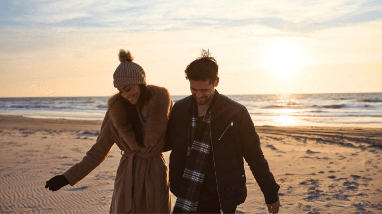 Couple walking on the beach in winter