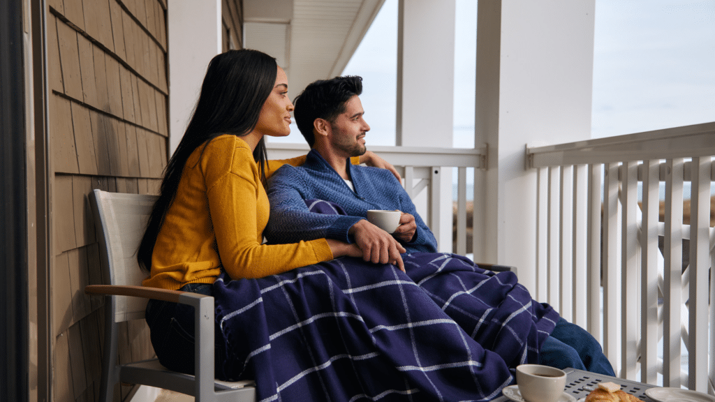 Couple on the balcony of a beach resort during winter