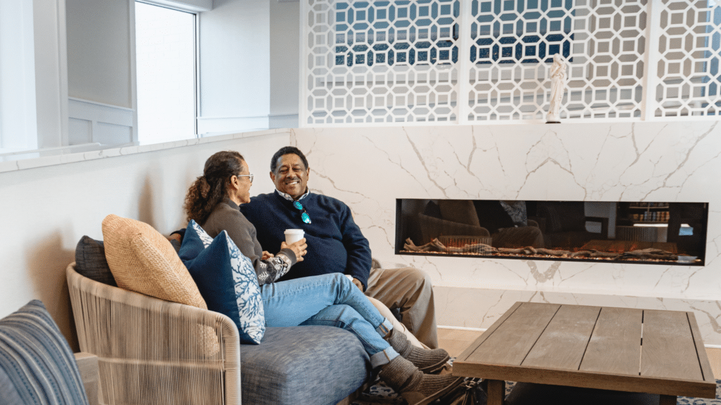 Couple curled up in the lobby of ICONA Diamond Beach in Wildwood in Winter