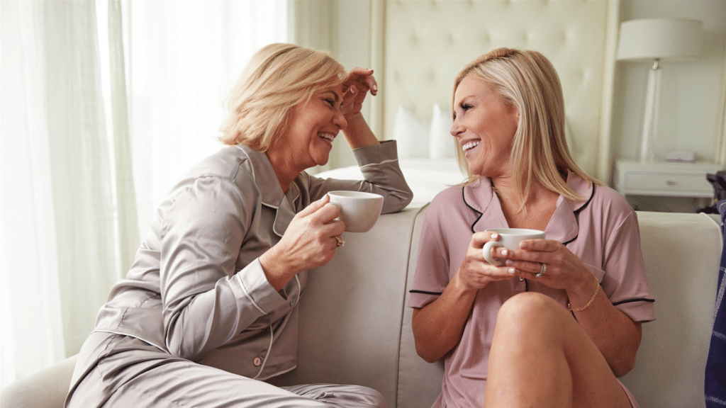 Two friends sharing tea in an ICONA hotel room