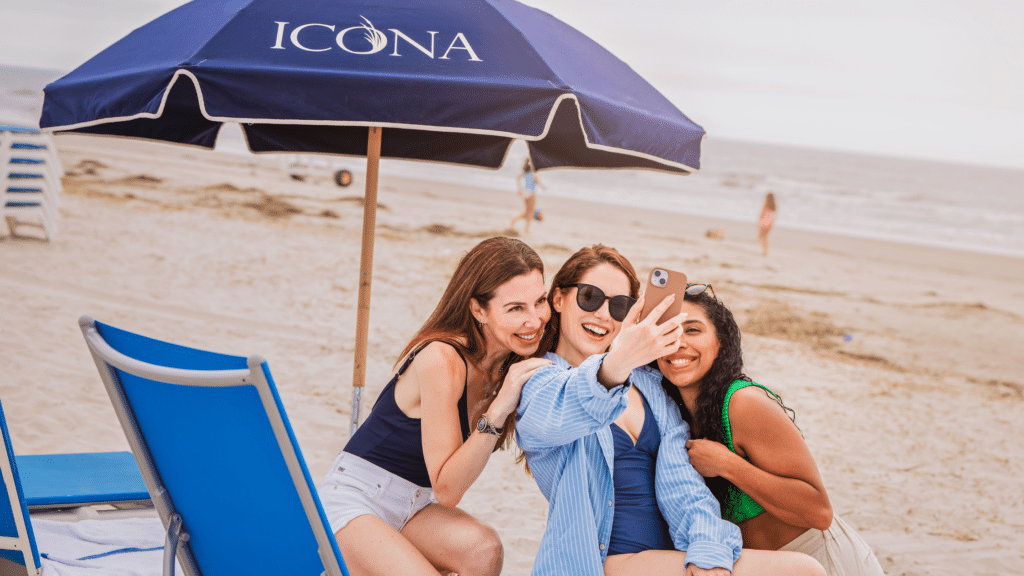 Three friends posing for a selfie at the beach